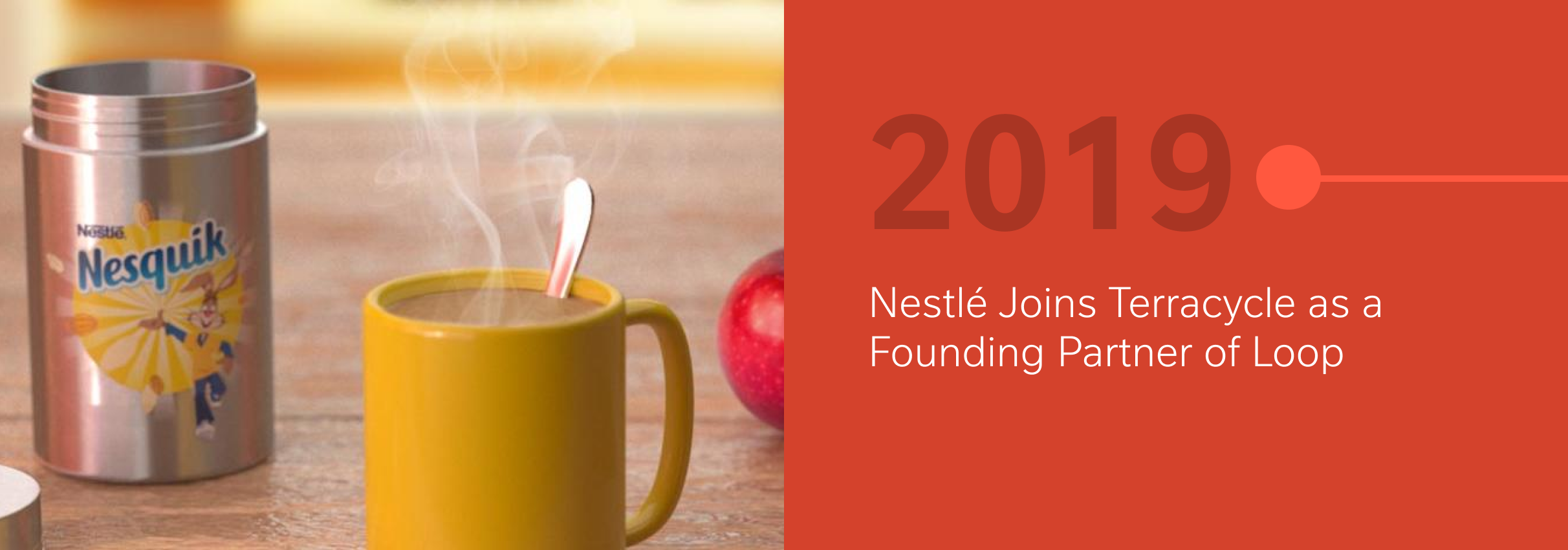 Yellow Nesquik container and mug with steam, red apple in background, 2019 milestone text.