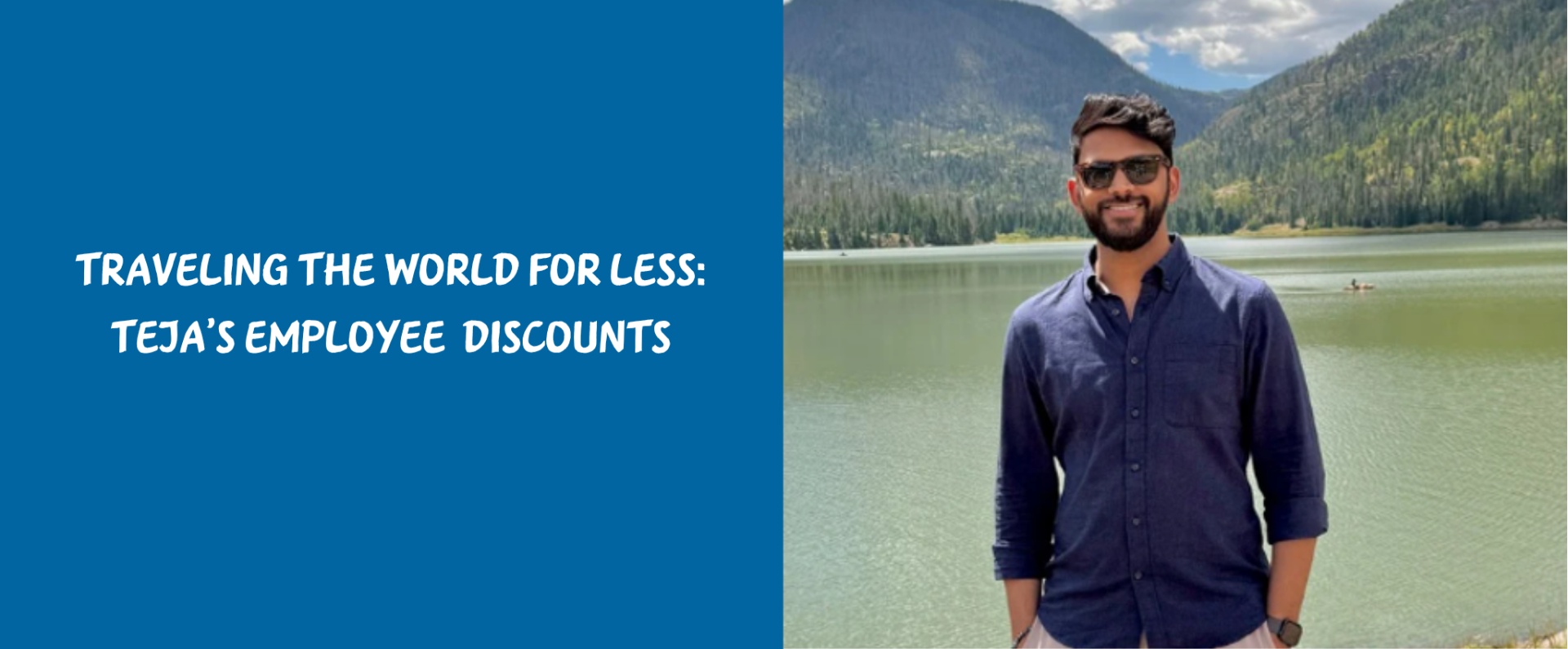 Person standing by a lake with forested mountains in the background