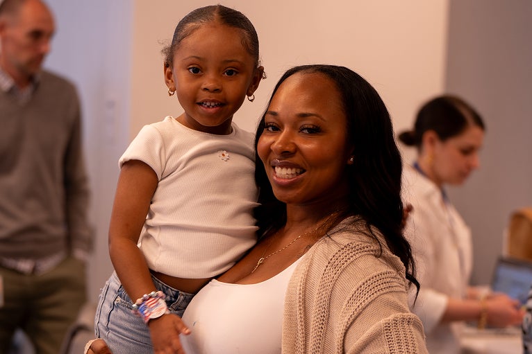 Woman holding her small child