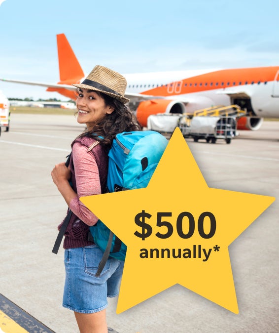 Woman with a blue backpack smiling on an airport tarmac near an orange airplane.