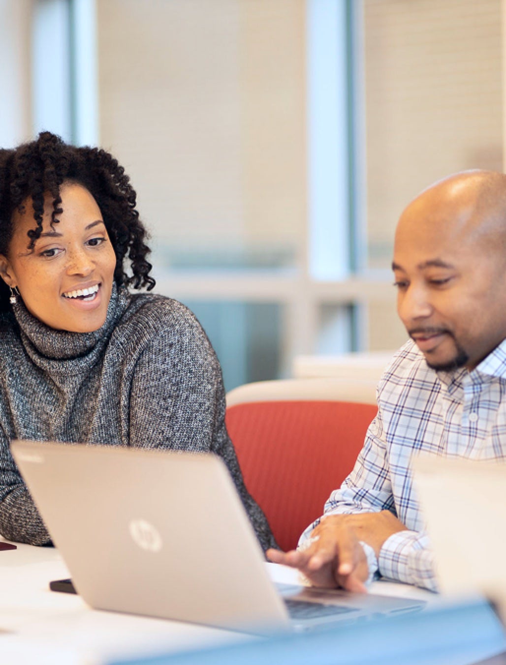 Two associates working together at a laptop
