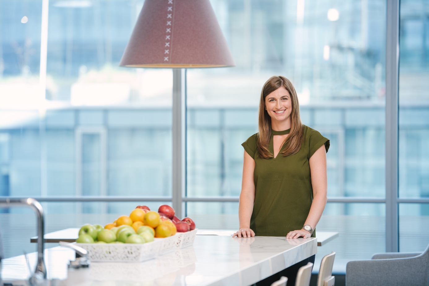 Woman smiling in office kitchen