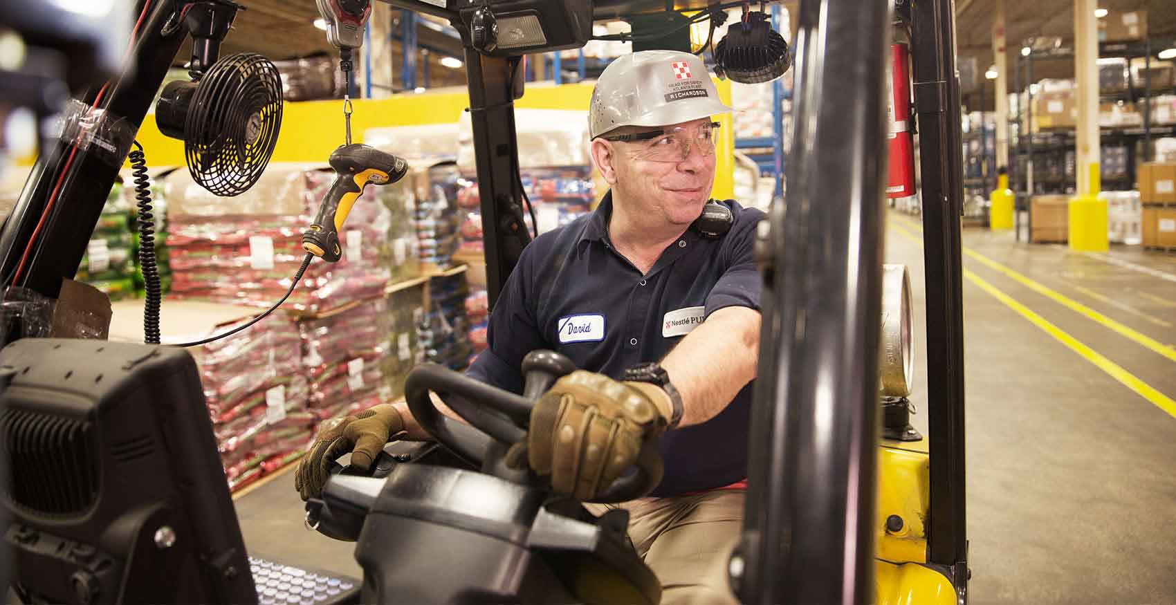 Purina associate driving a forklift