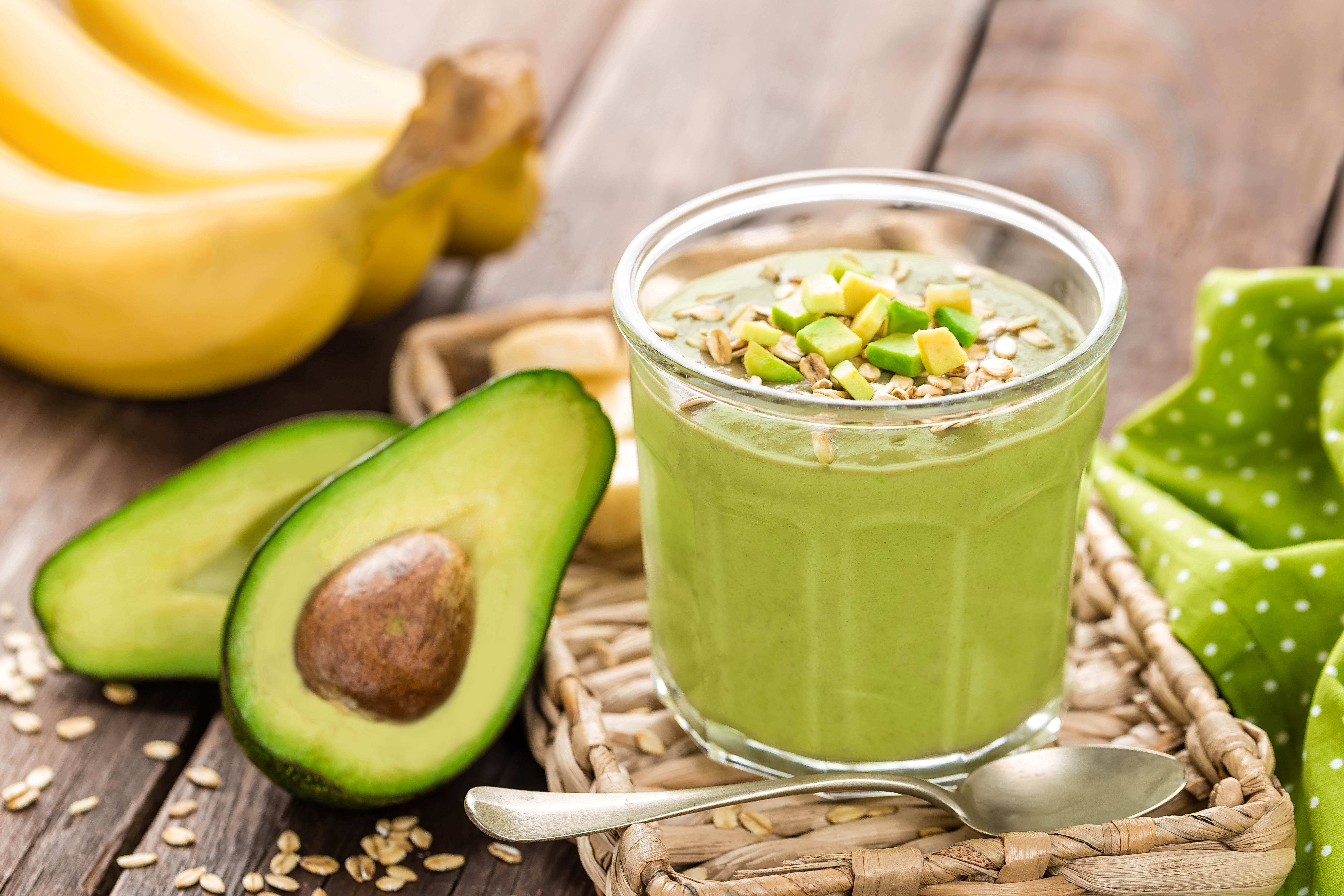  Avocado resting next to a cup of pudding 