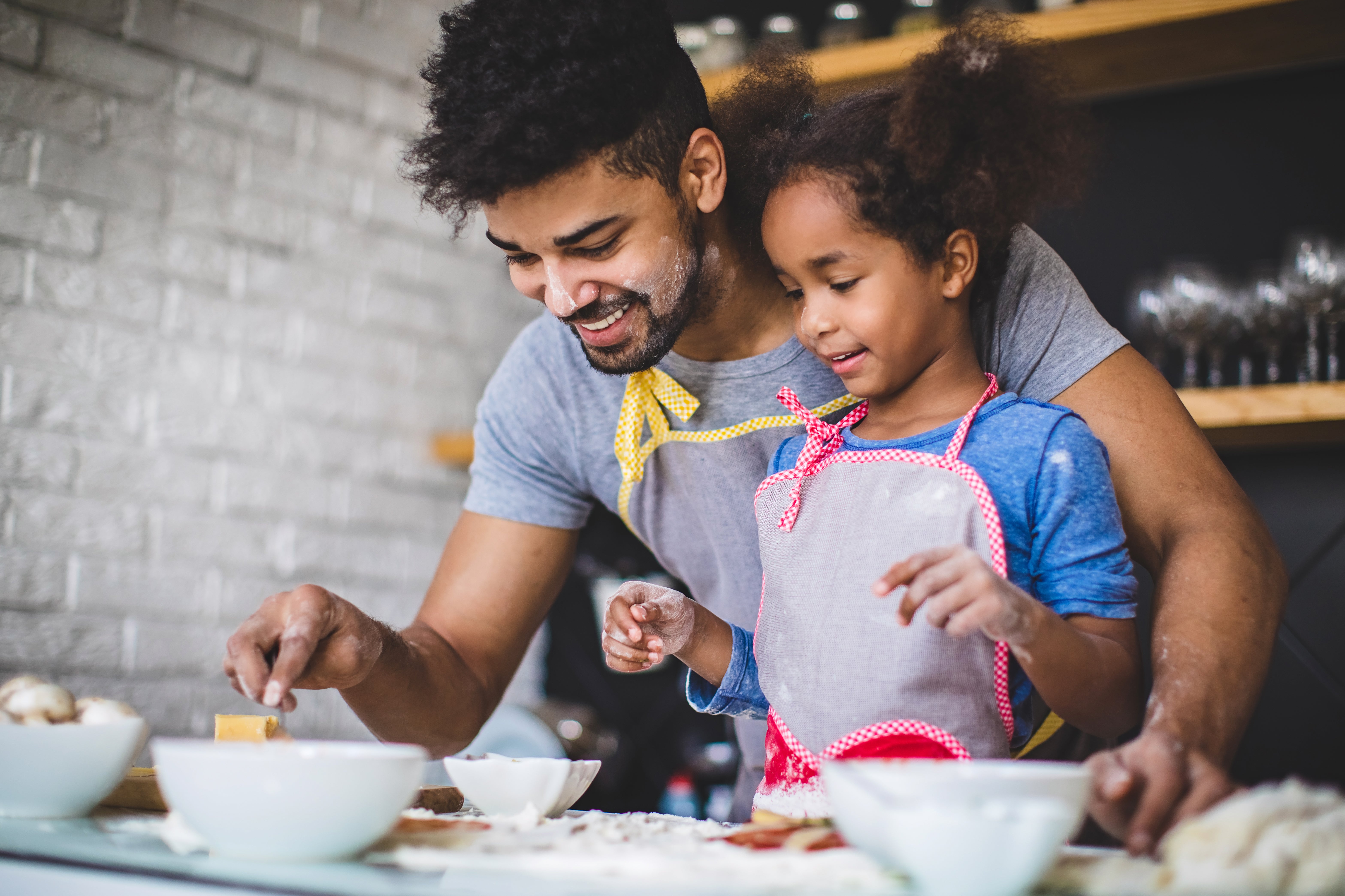 Father and daughter making a pizza together