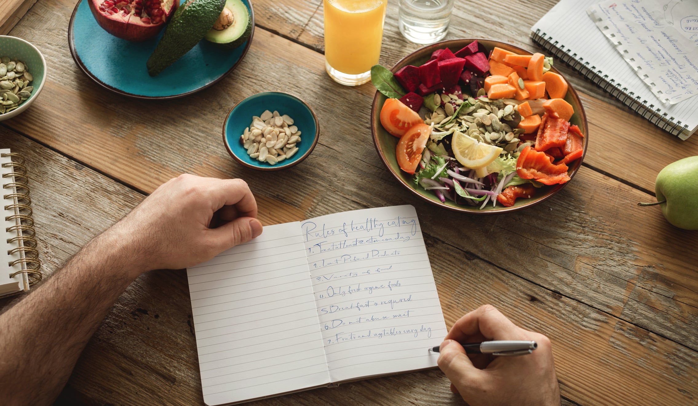 Someone eating a snack with a notebook