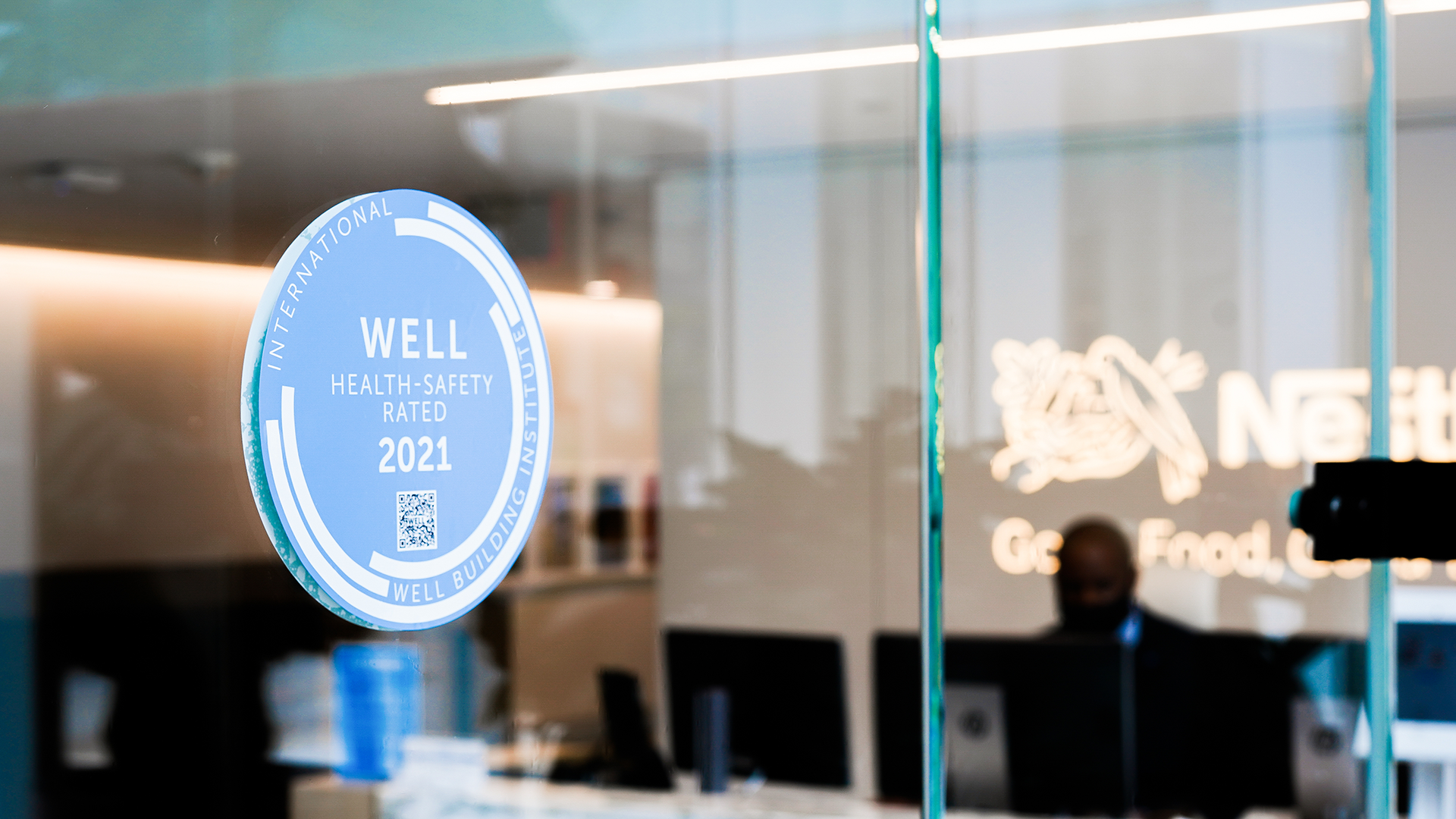 Well Safety Rated 2021 seal on a glass door