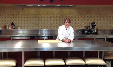 Woman standing at steel table