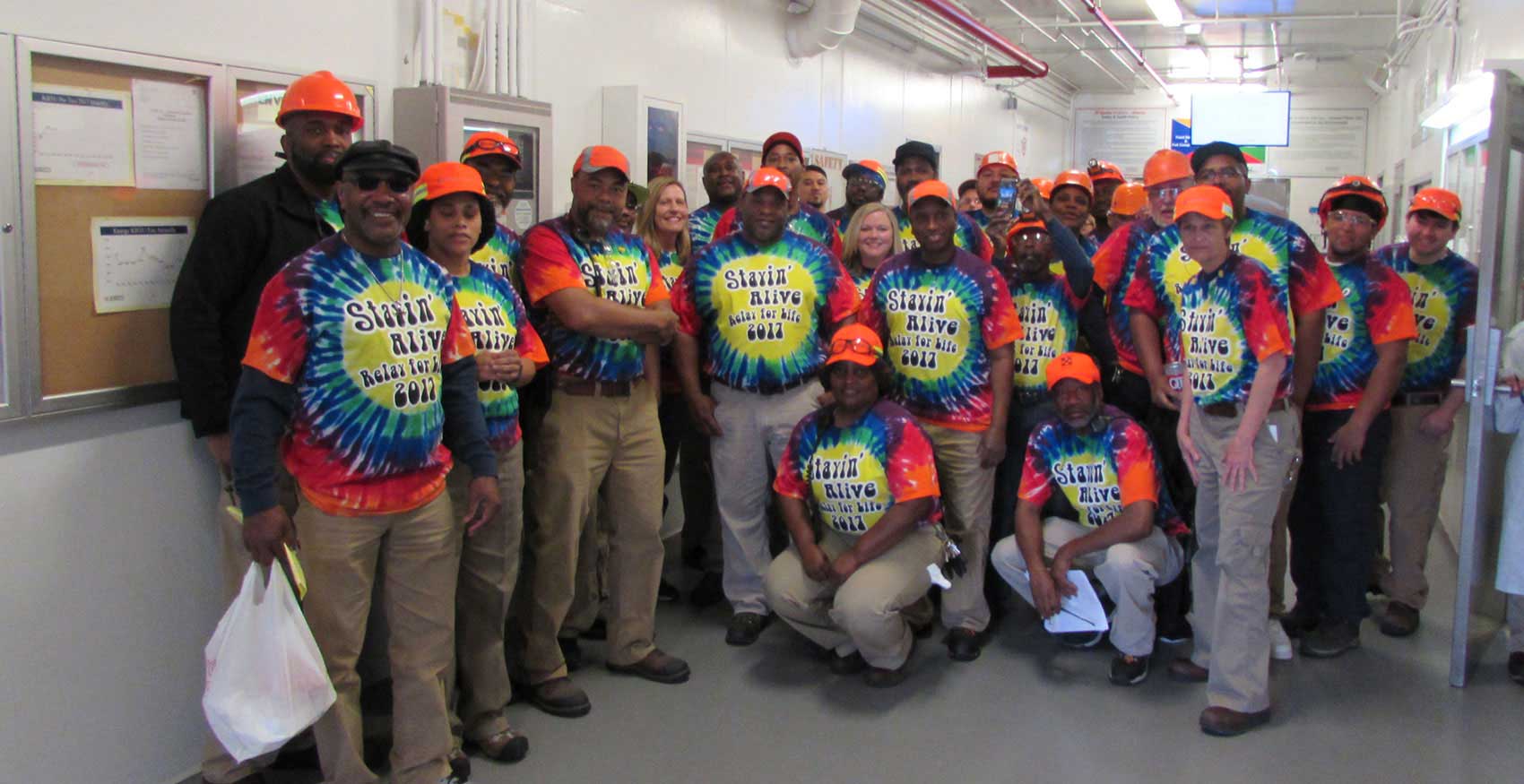 Associates with tie dye Relay for Life shirts on standing together