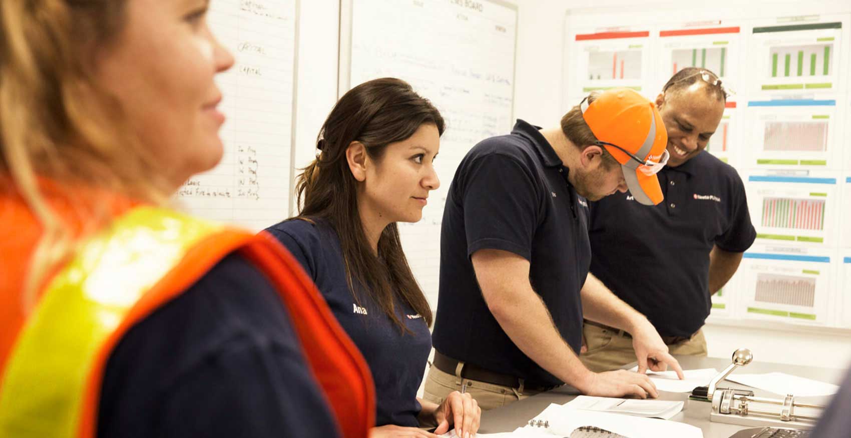 Group of associates collaborating in room