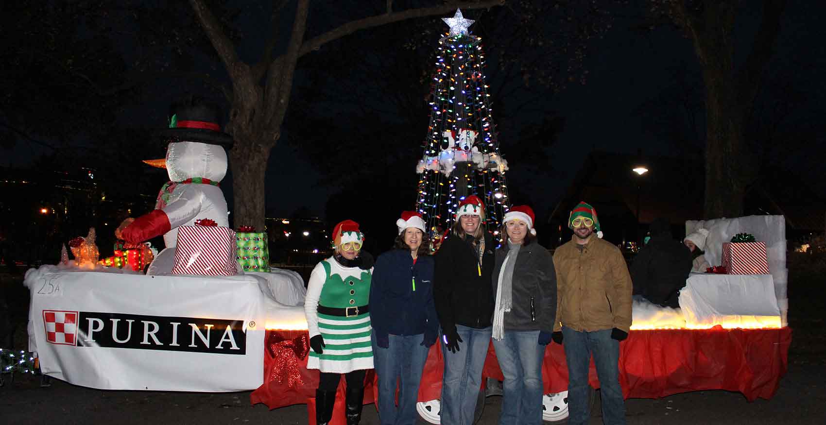 Associates standing outside infront of Christmas tree