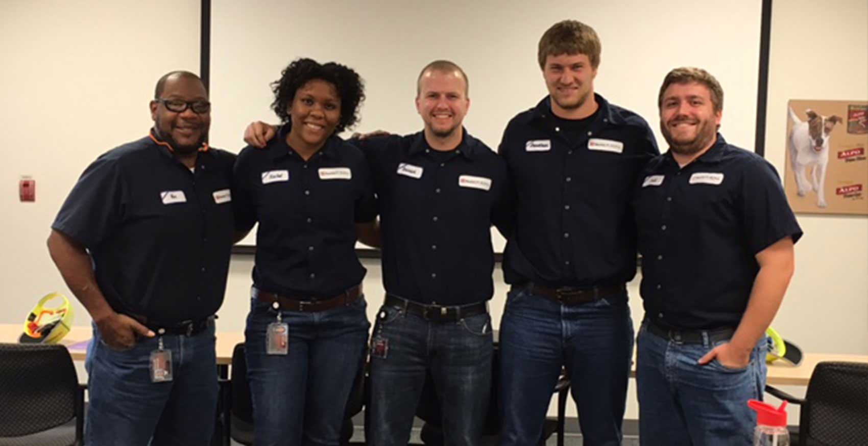 Associates smiling and standing together
