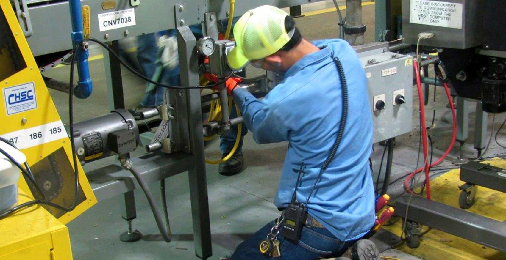Man working on machinery in factory
