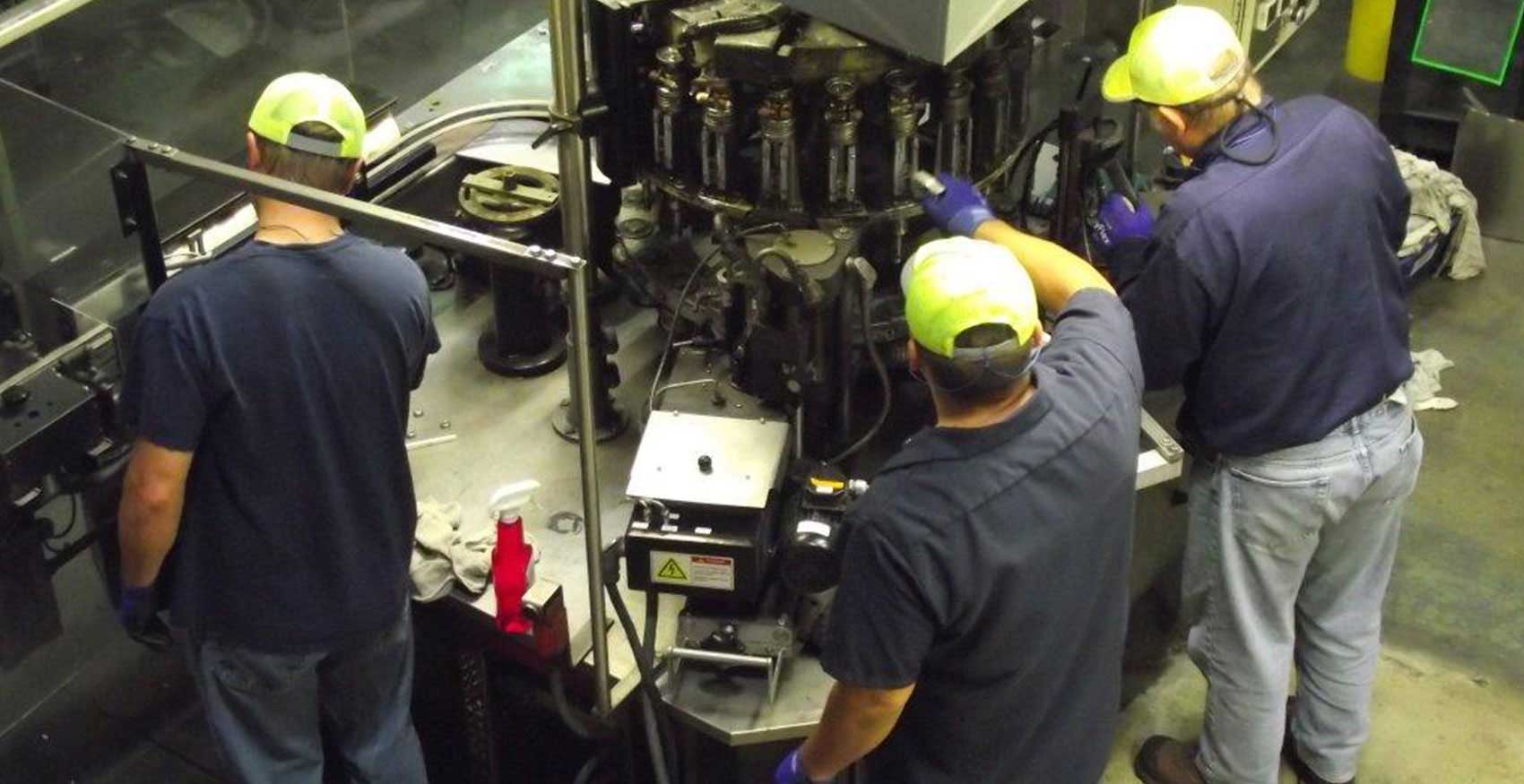 Men working on machinery in factory