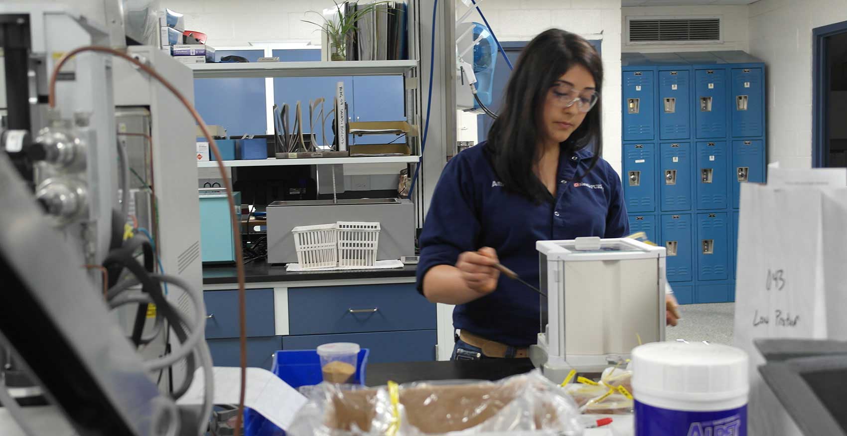 Woman working in factory with safety glasses on