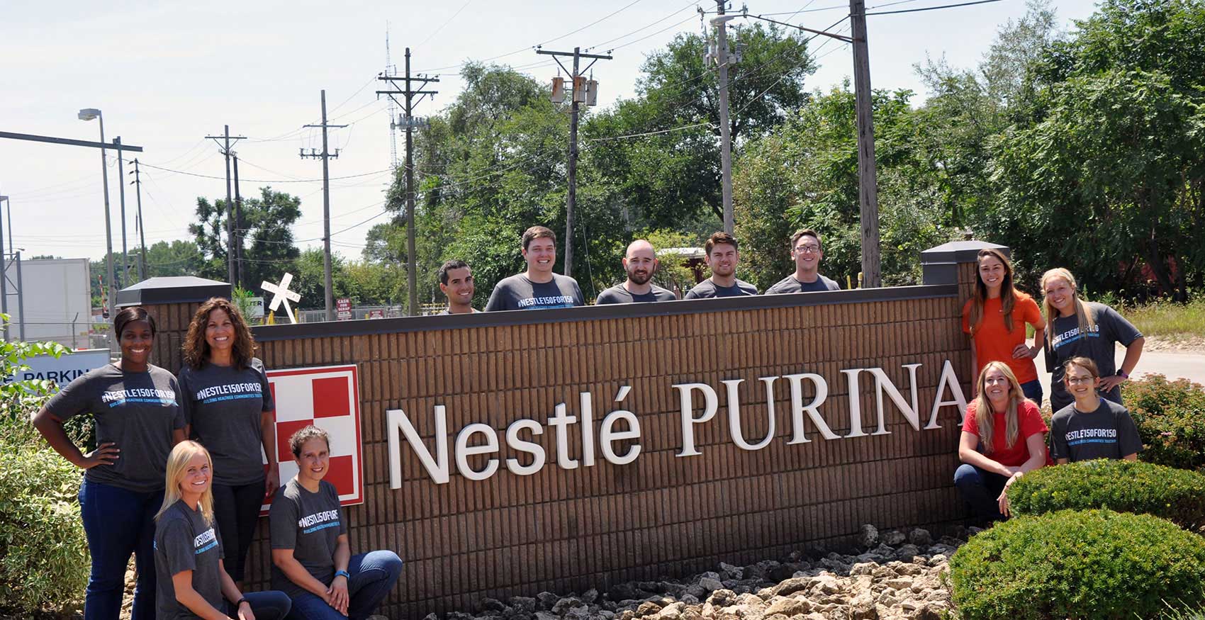Associates standing in front of Davenport, IA Nestlé Purina sign