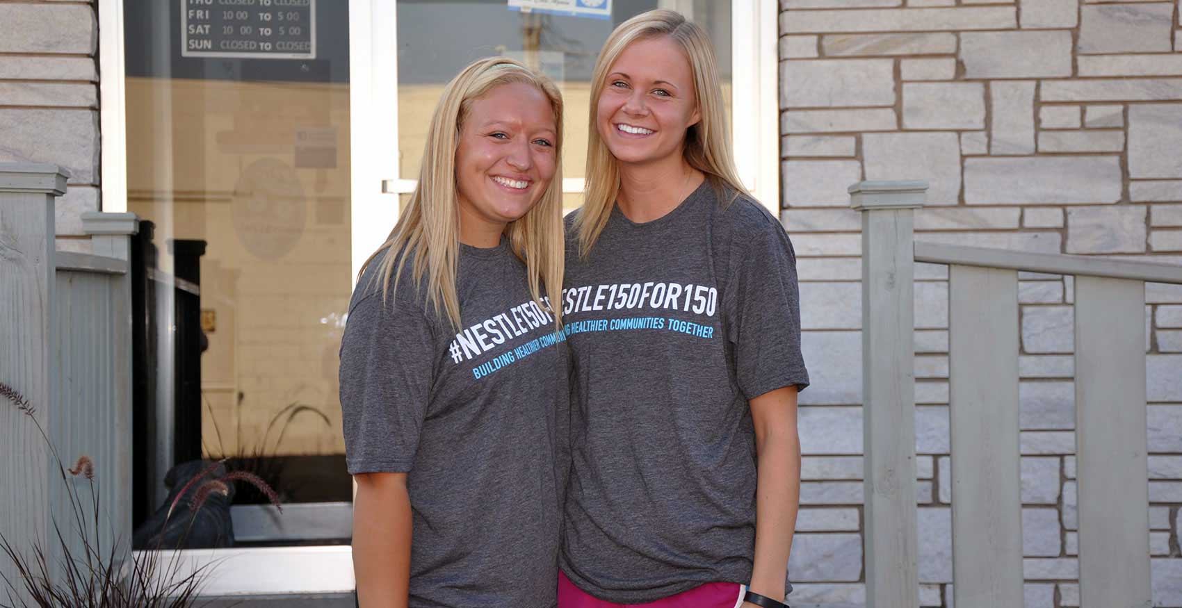 Two women smiling and standing up