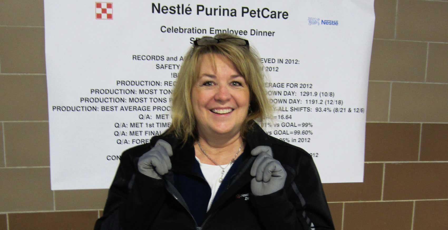 Woman smiling and holding her collar