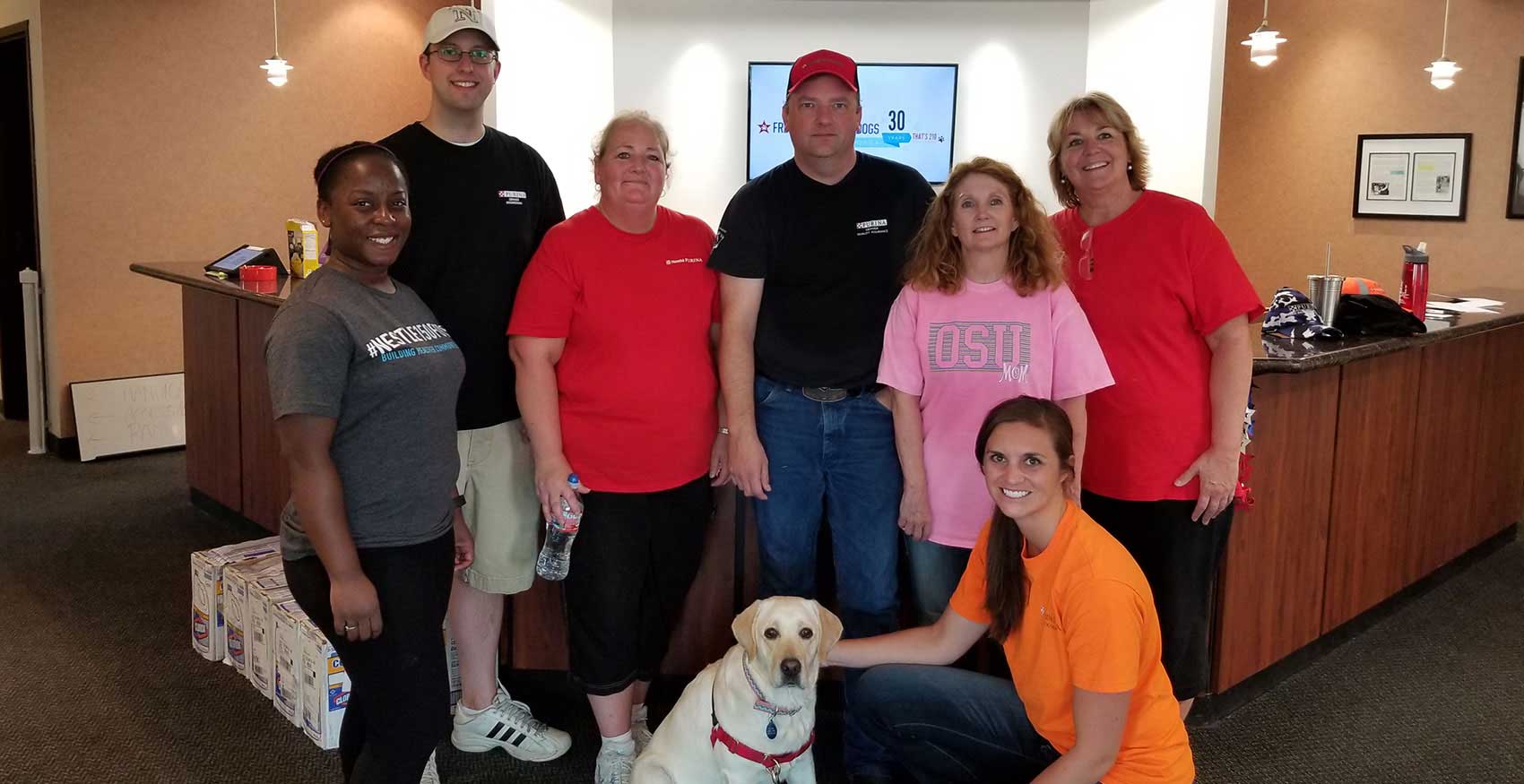 Associates standing together with dog