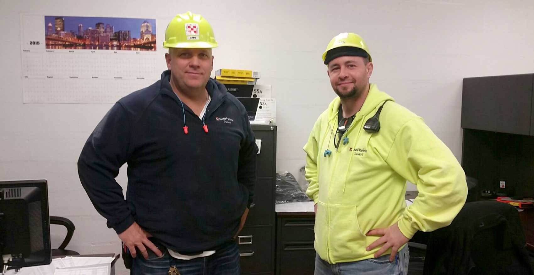 Dunkirk associates smiling and standing together