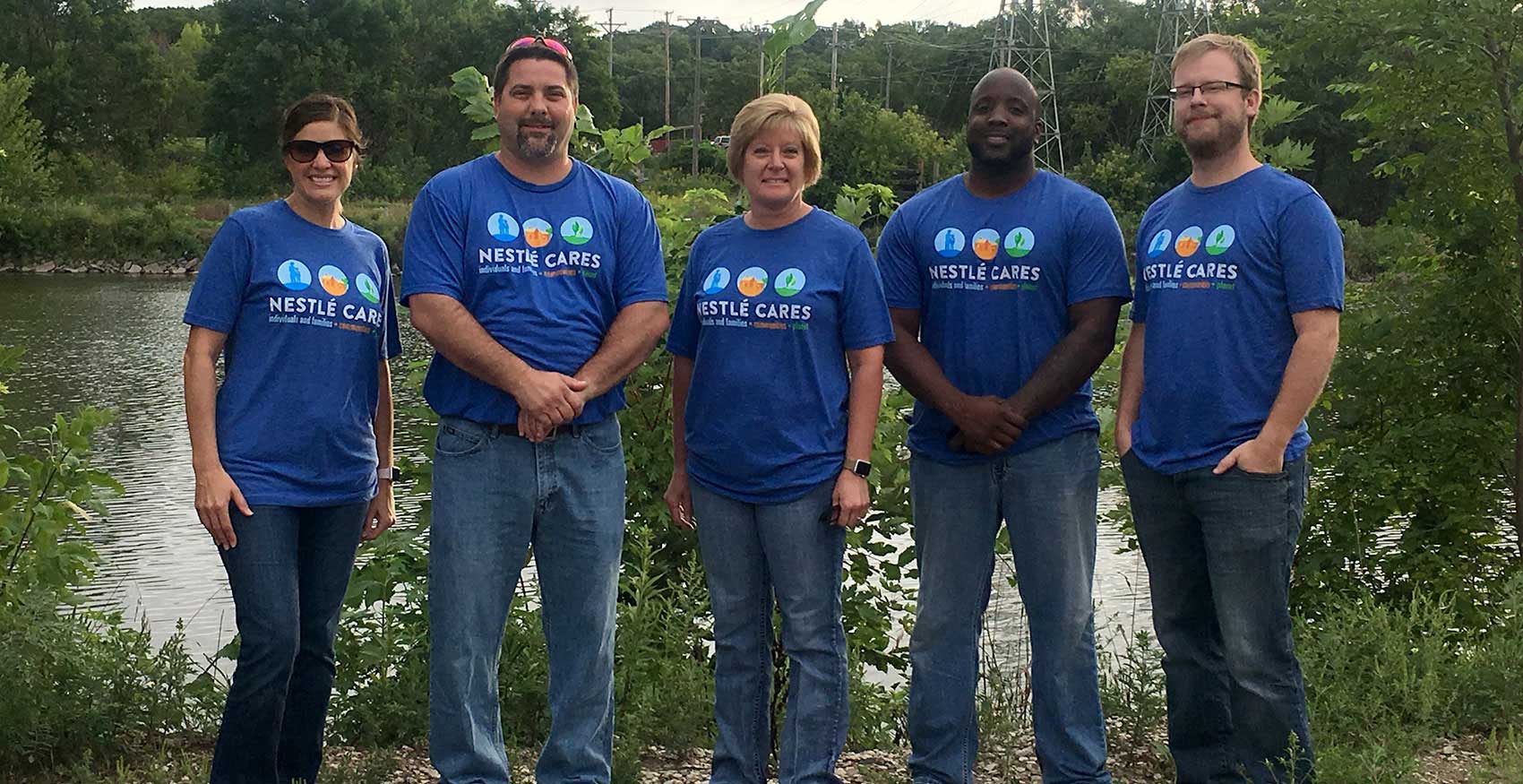 Associates standing outside with blue Nestlé t-shirts on