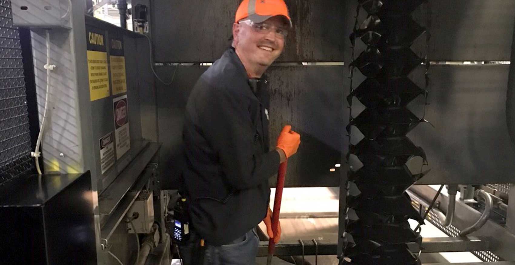 Man standing with broom on factory floor