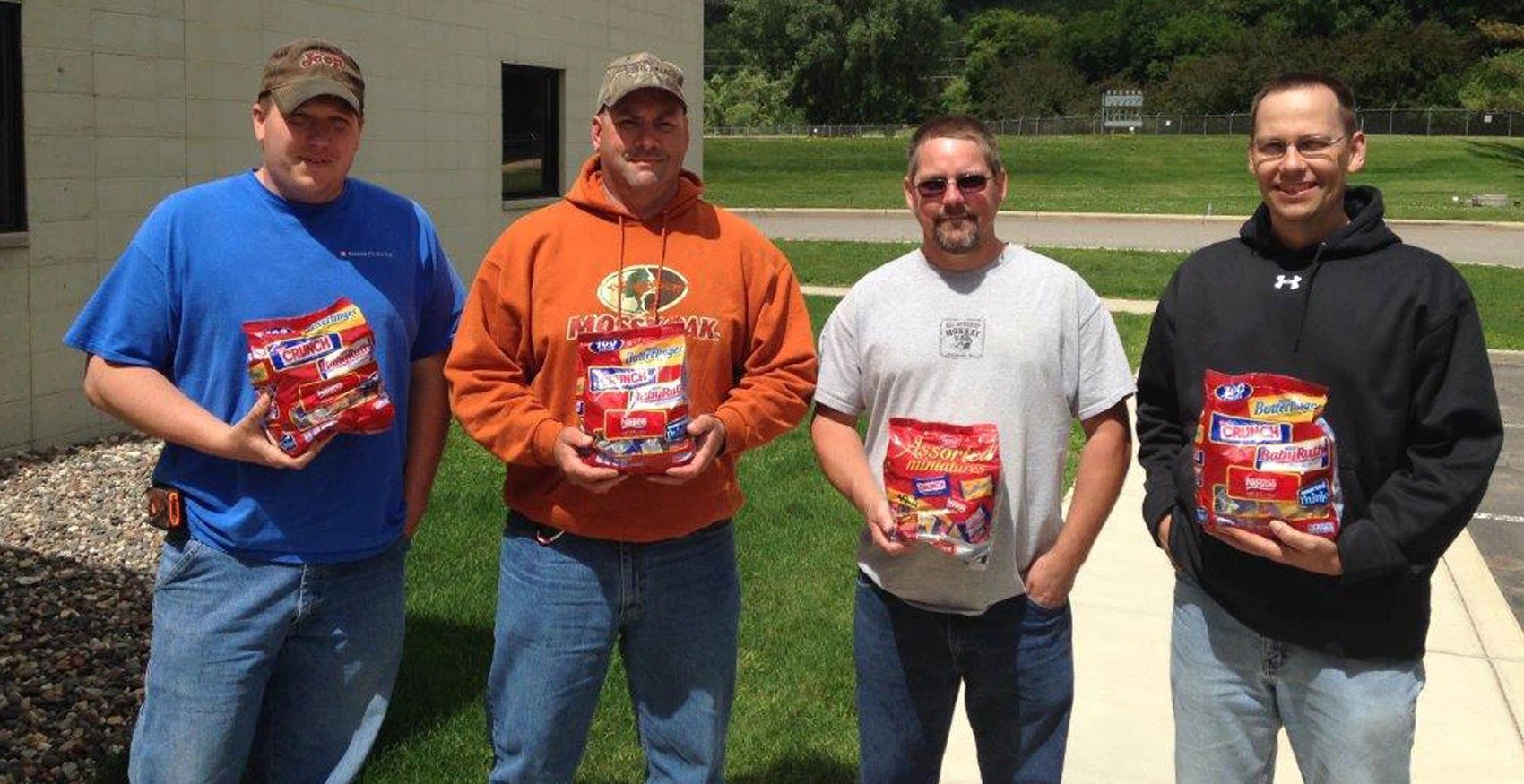 Men standing outside of factory