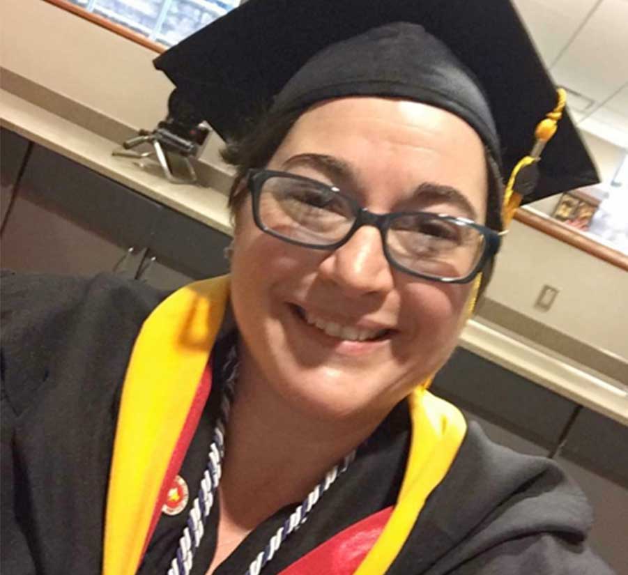 headshot of Jennifer in cap and gown