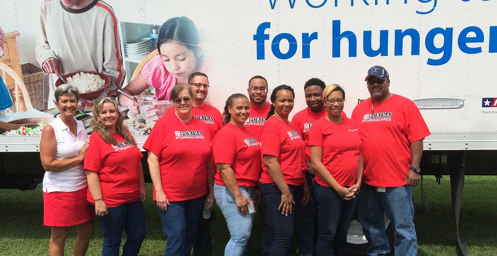 Team of purina workers posing for a pic at a volunteering event