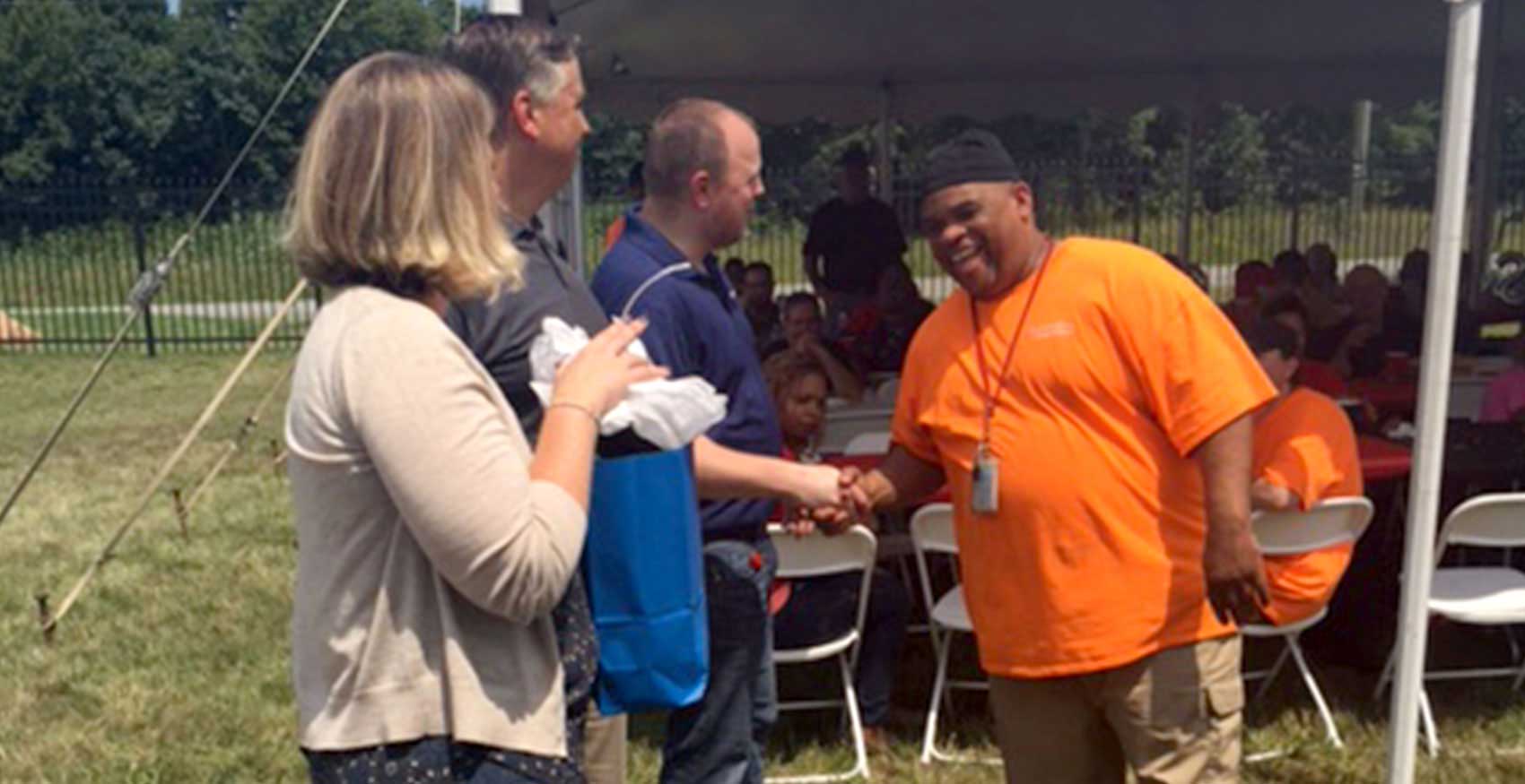People shaking hands at a volunteer event