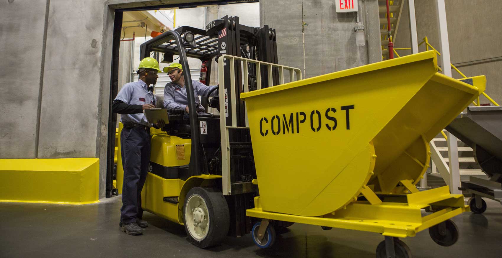 Men operating forklift