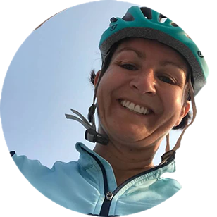 Woman smiling on bike with helmet on