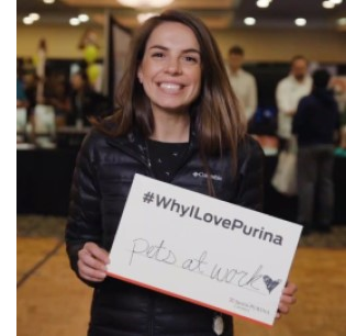 Woman holding why I love Purina sign