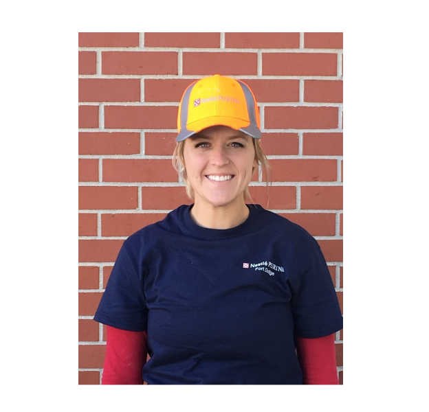 Woman smiling with Purina hat on