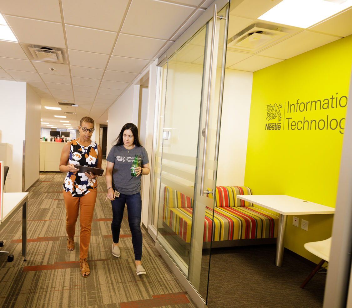 women walking down hallway