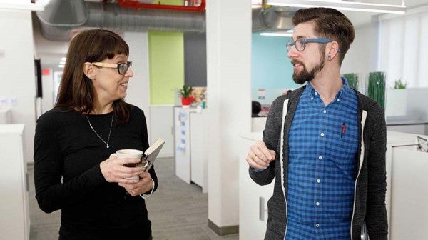 Man and woman conversing in hallway