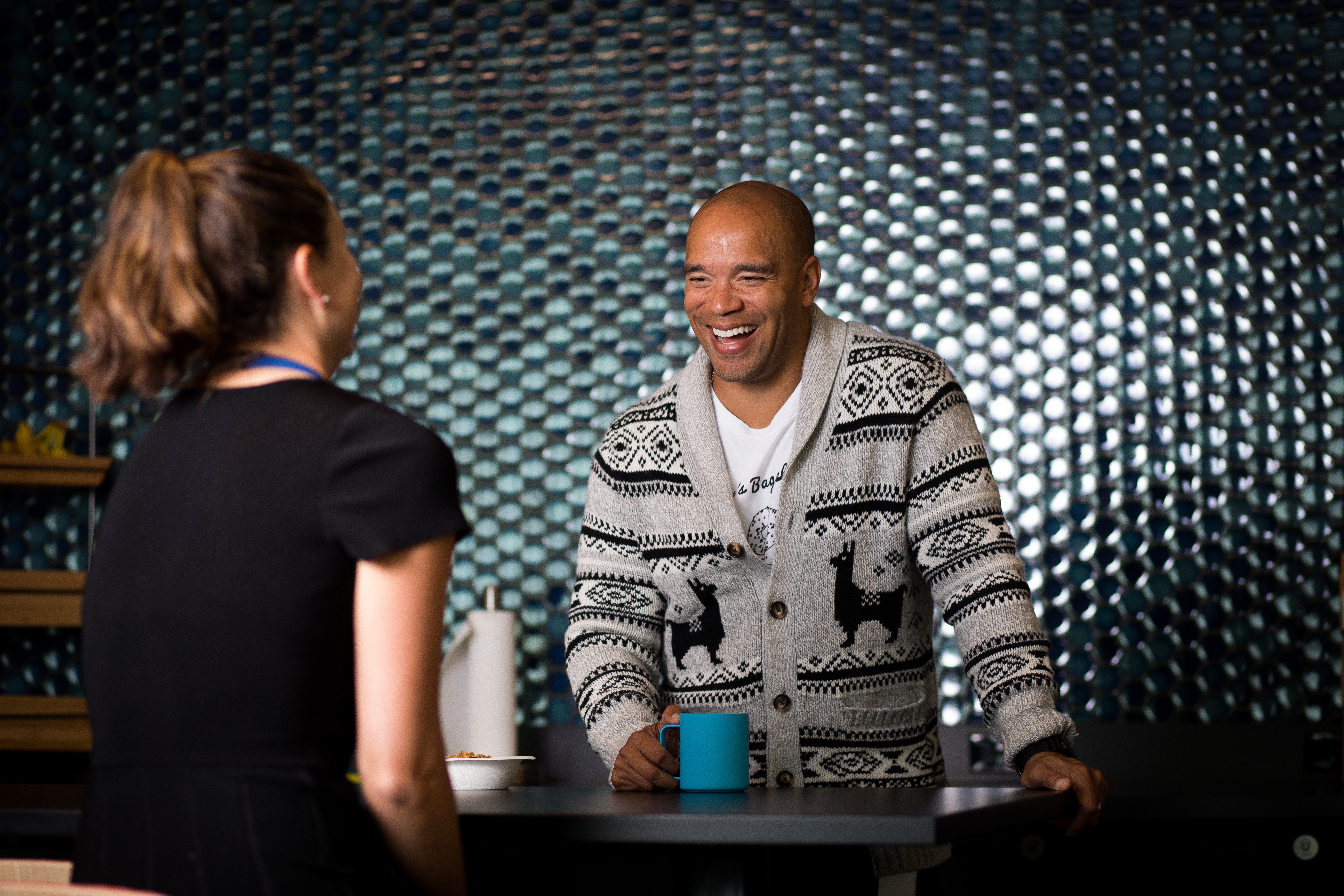Man collaborating and laughing with team member