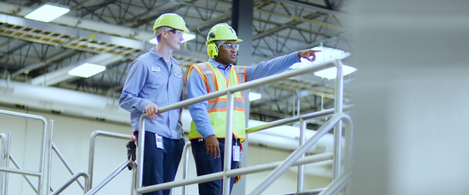 Young worker being trained by veteran employee
