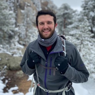 Man standing snow smiling