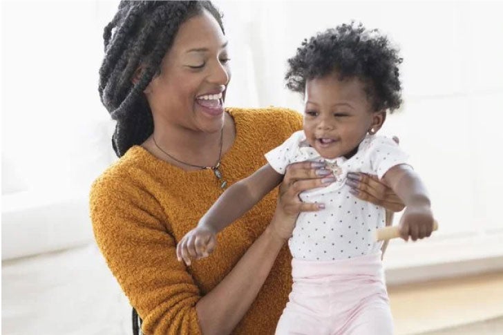 Mom playing with her baby at home