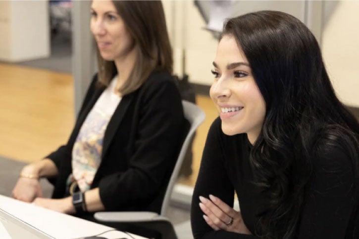 2 female employees in a conference room