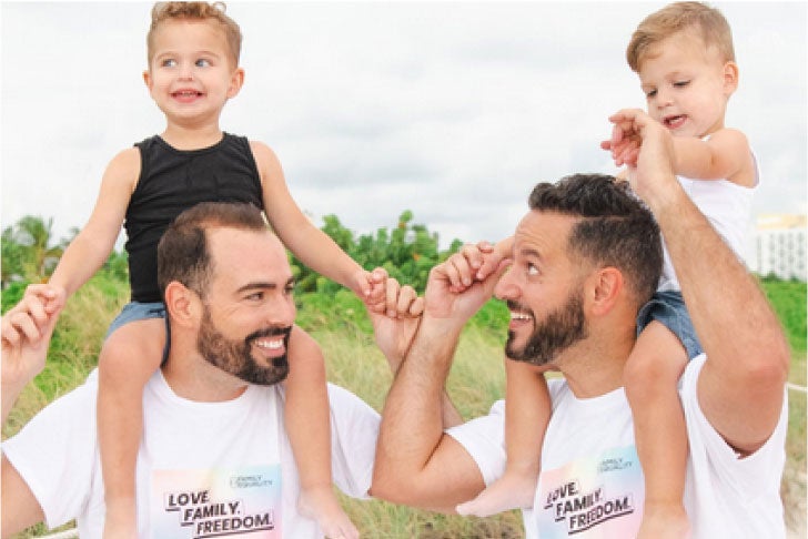 Two men with children on their shoulders