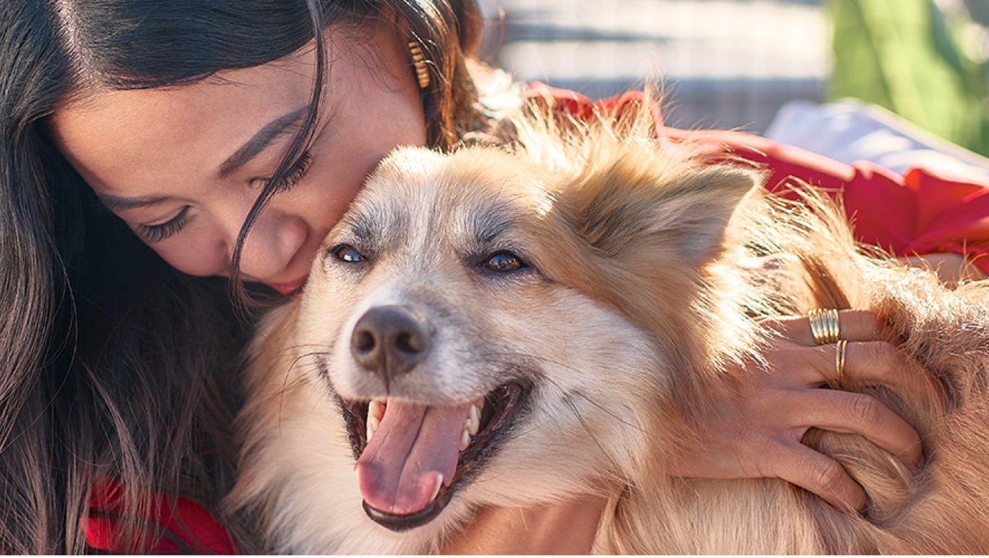 Woman hugging her fluffy dog