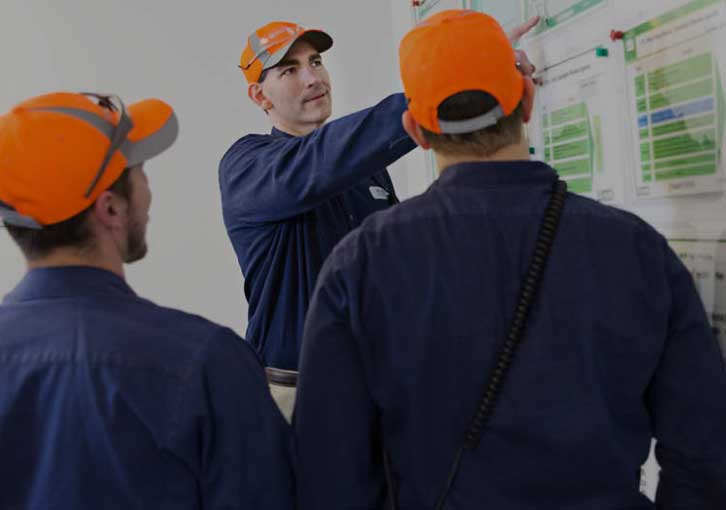 3 Nestle apprentices at a whiteboard