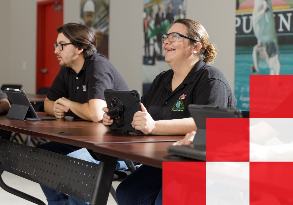 Three people gathered around a table, smiling,