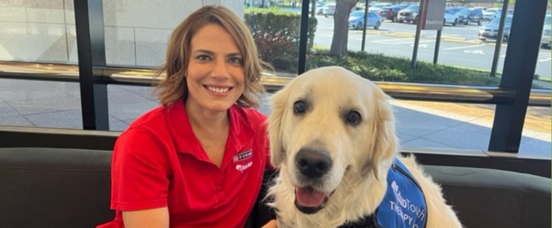 Purina employee with her golden retriever