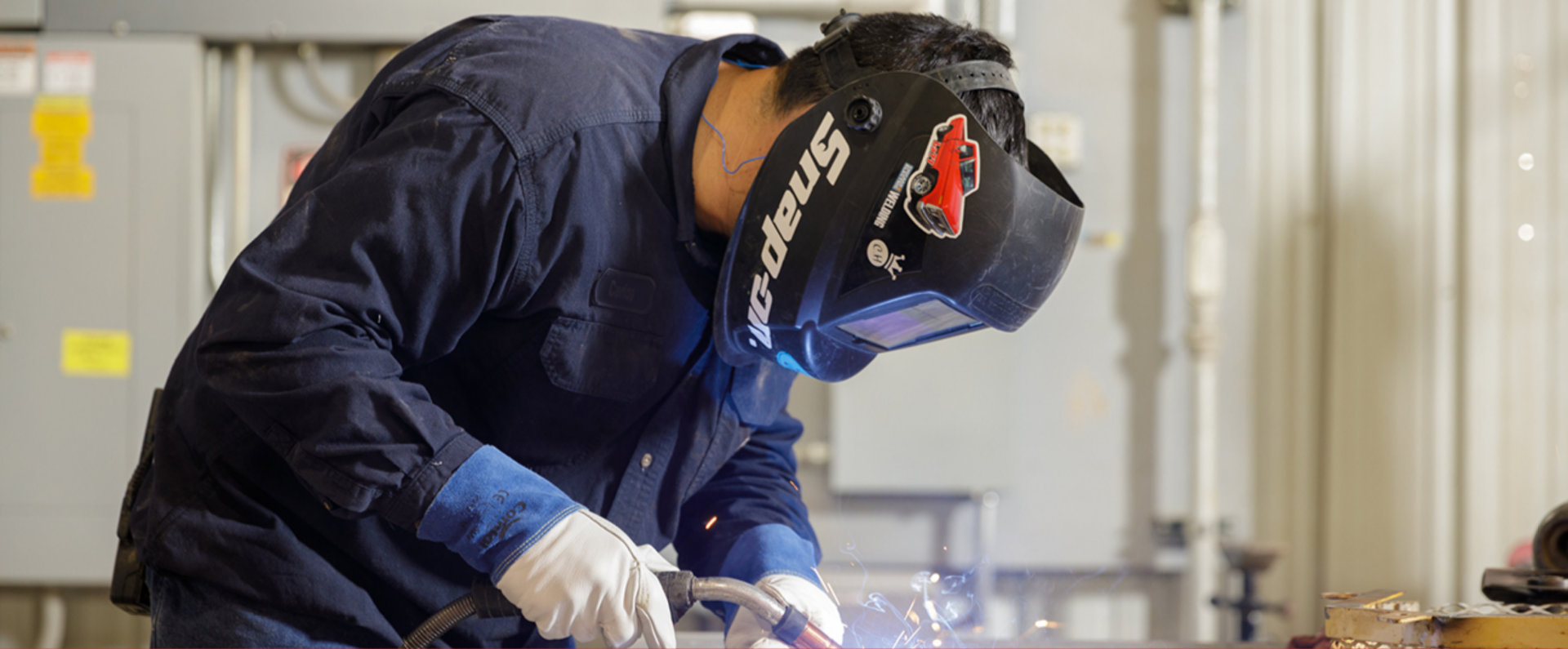 Man using protective gear in a factory setting