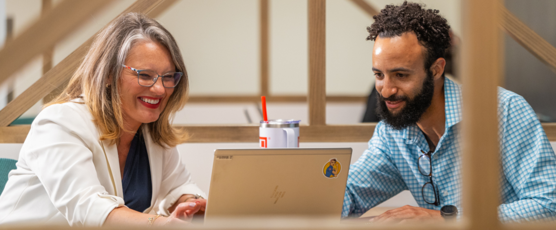 looking at laptop smiling with colleague
