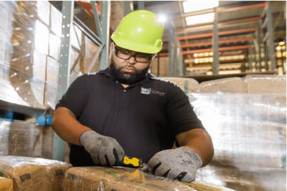 Purina factory worker opening plastic seal