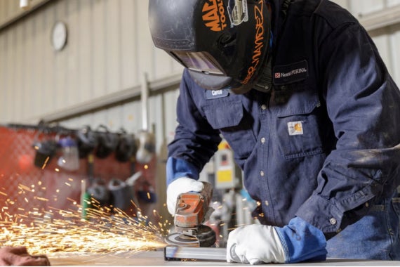 Purina factory worker using grinder